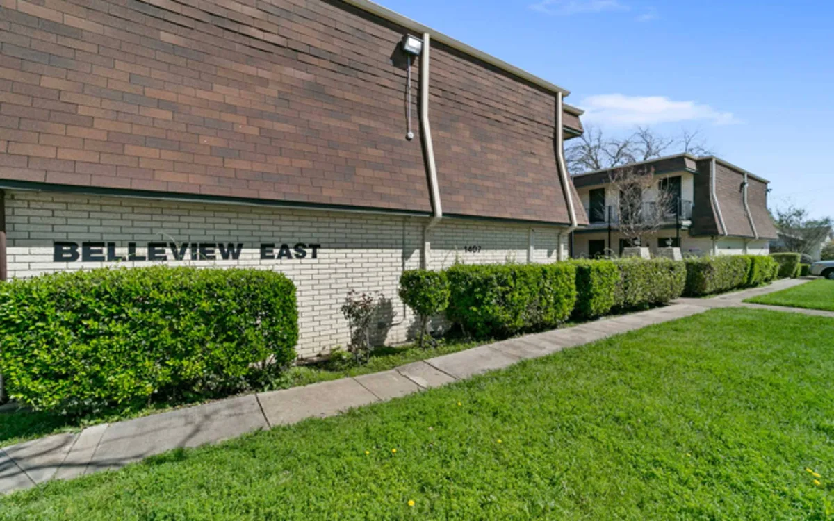 Belleview East two-story brick building with mansard roof and hedge-lined front walkway