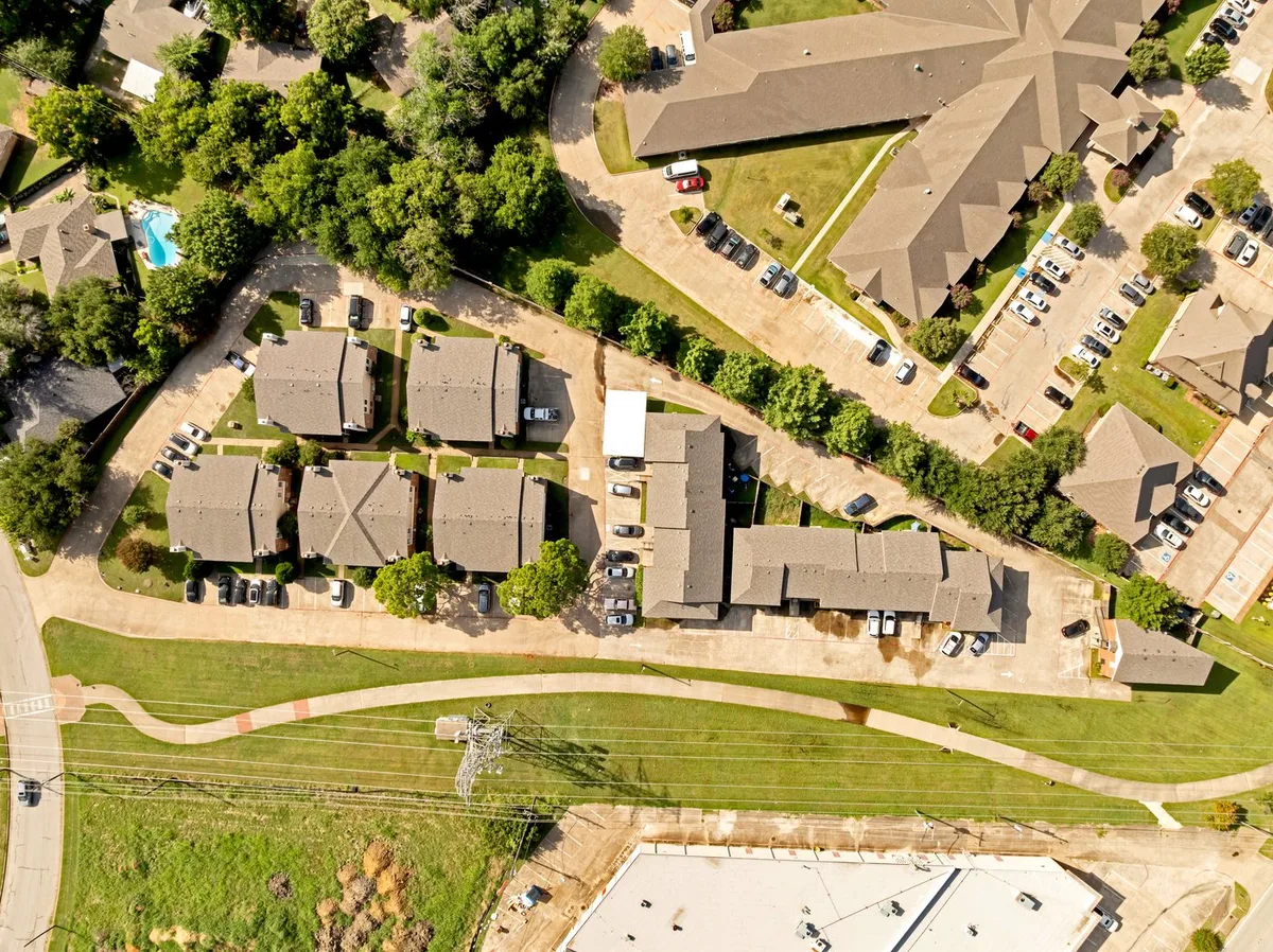 Aerial view of Davis Square showing the swimming pool courtyard among the townhome rooftops