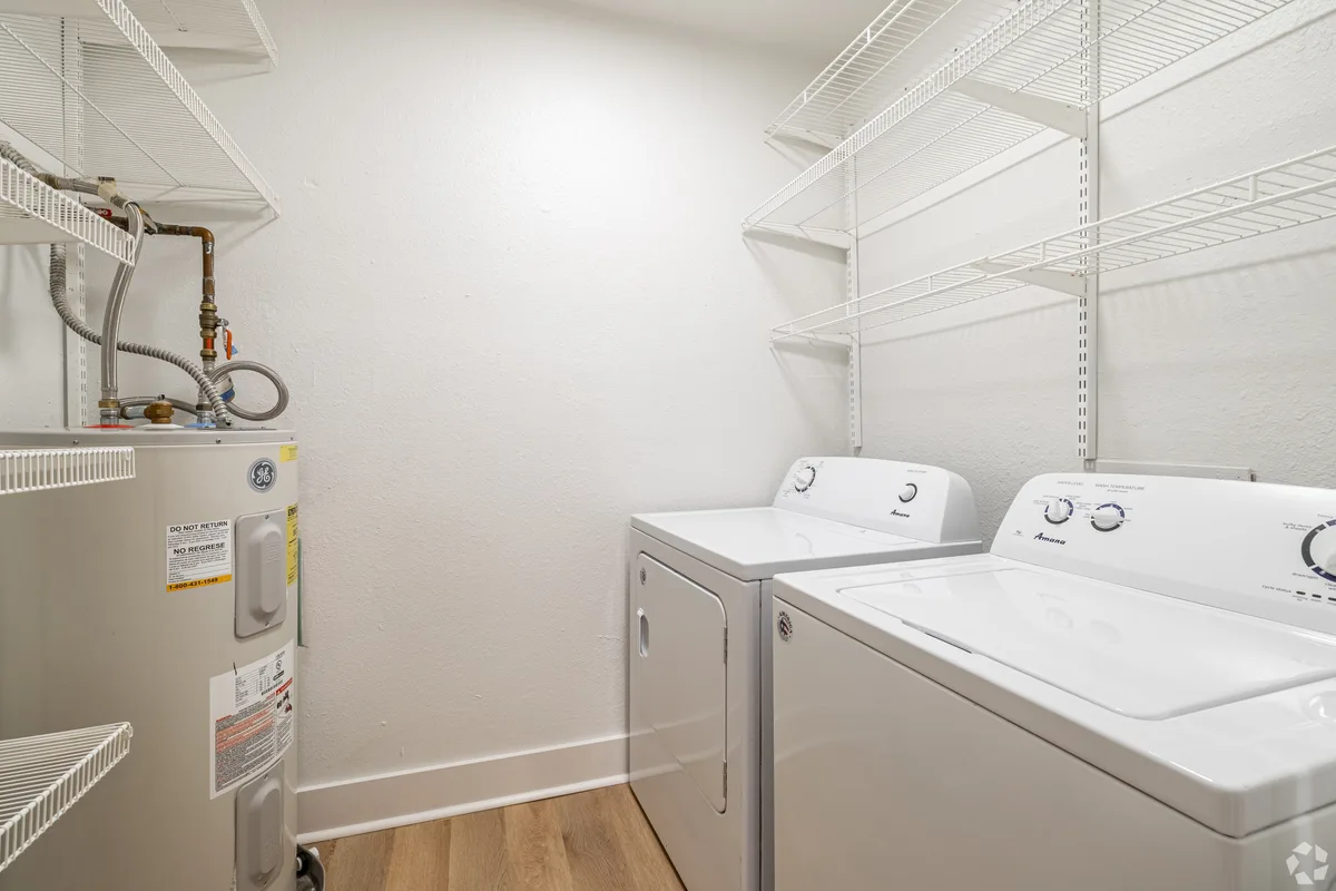 In-unit full-size washer, dryer, and water heater with wire shelving