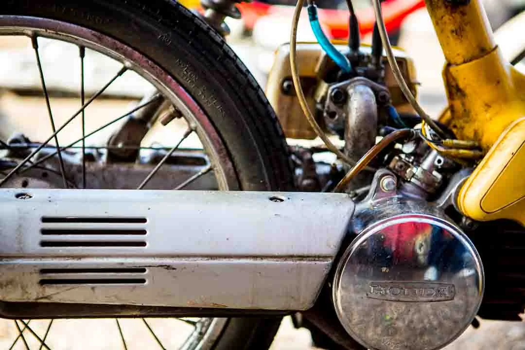 A vintage yellow moped, close up