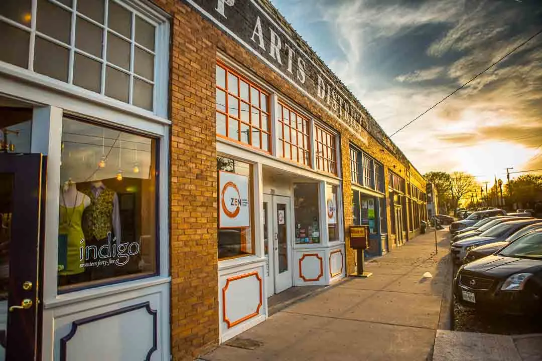 Brick storefronts along a Bishop Arts District street at sunset