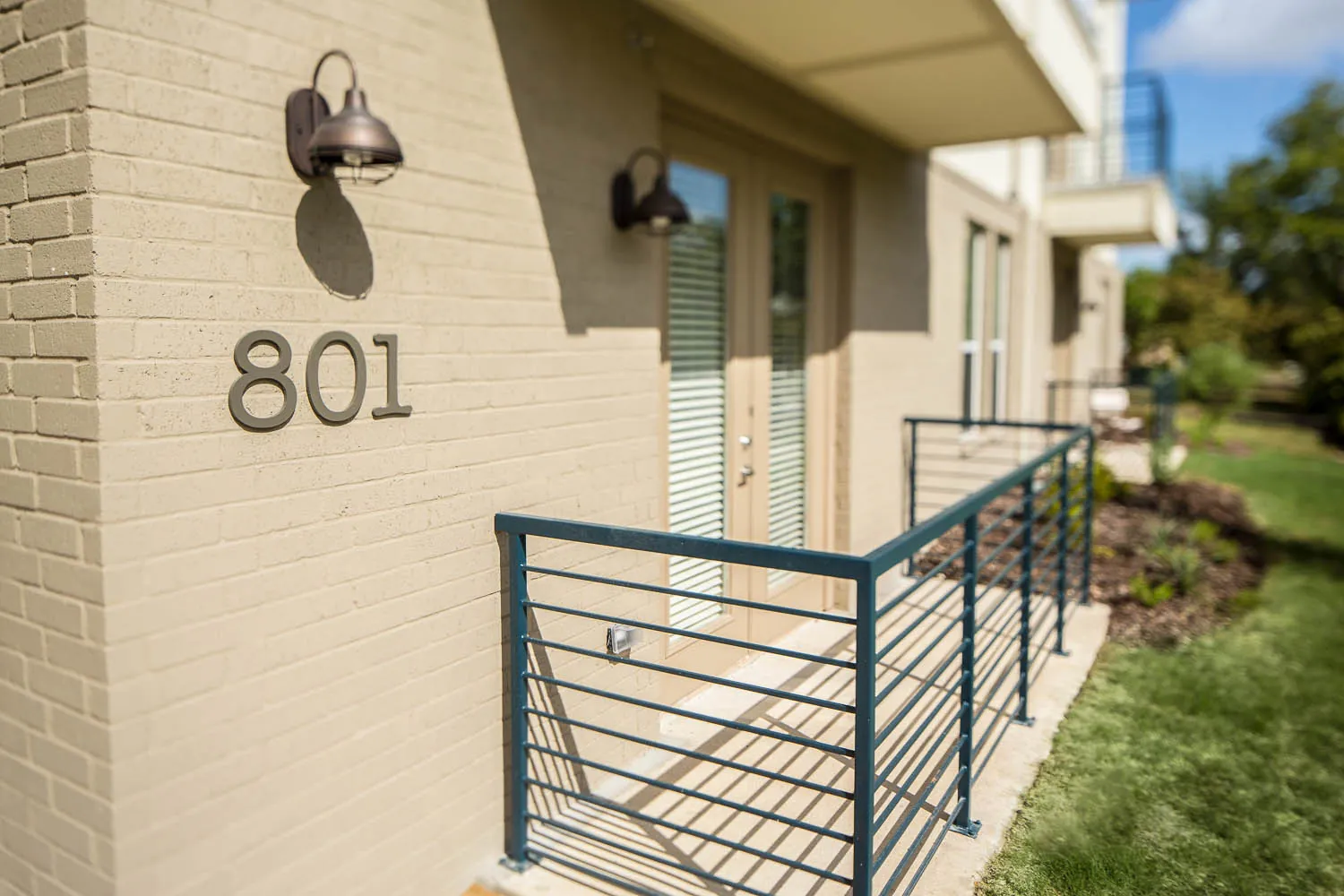 The 801 N Bishop Ave entry, with its address numbers and a steel rail along the front walk