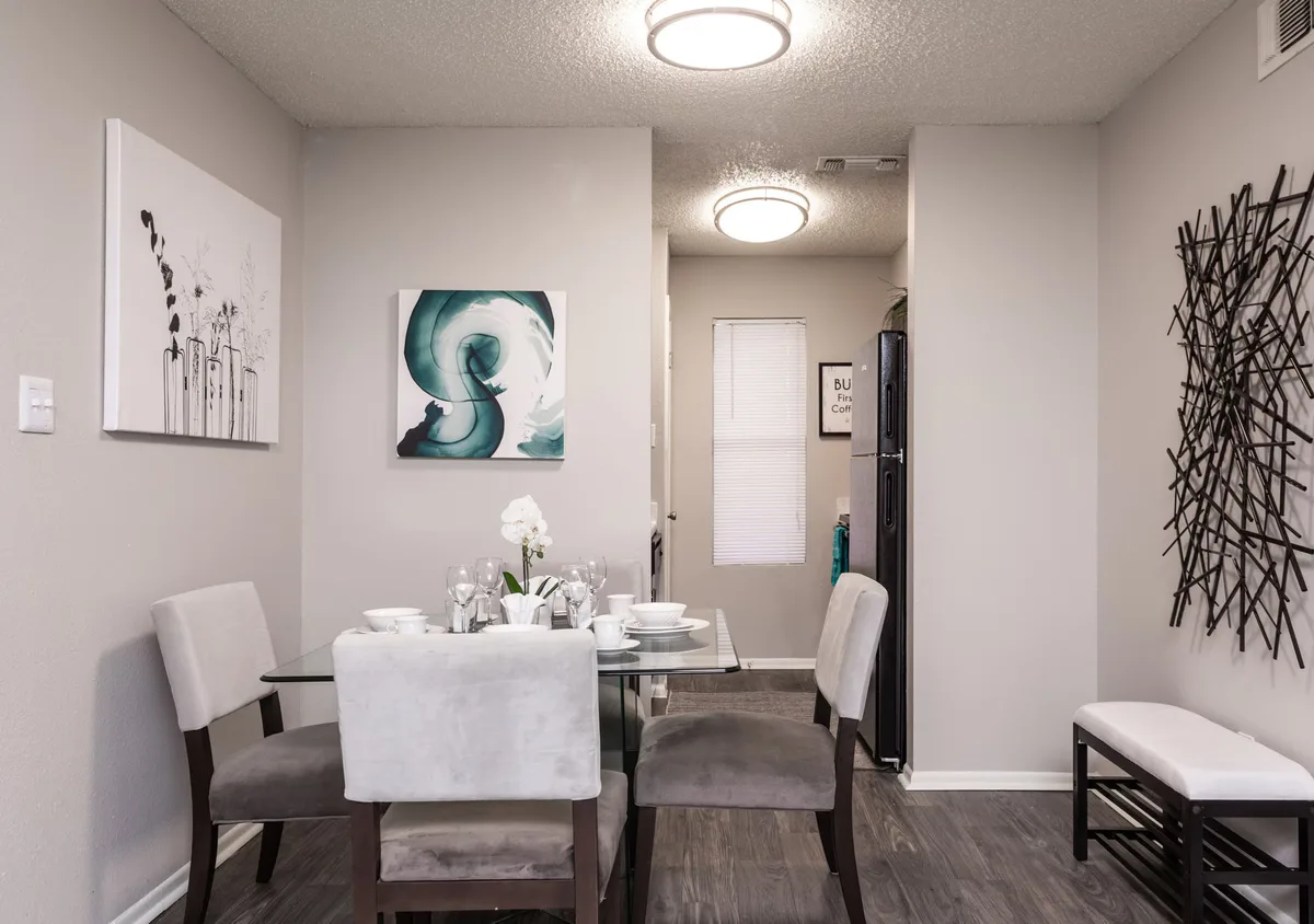 Dining area with a glass table for four open to the kitchen