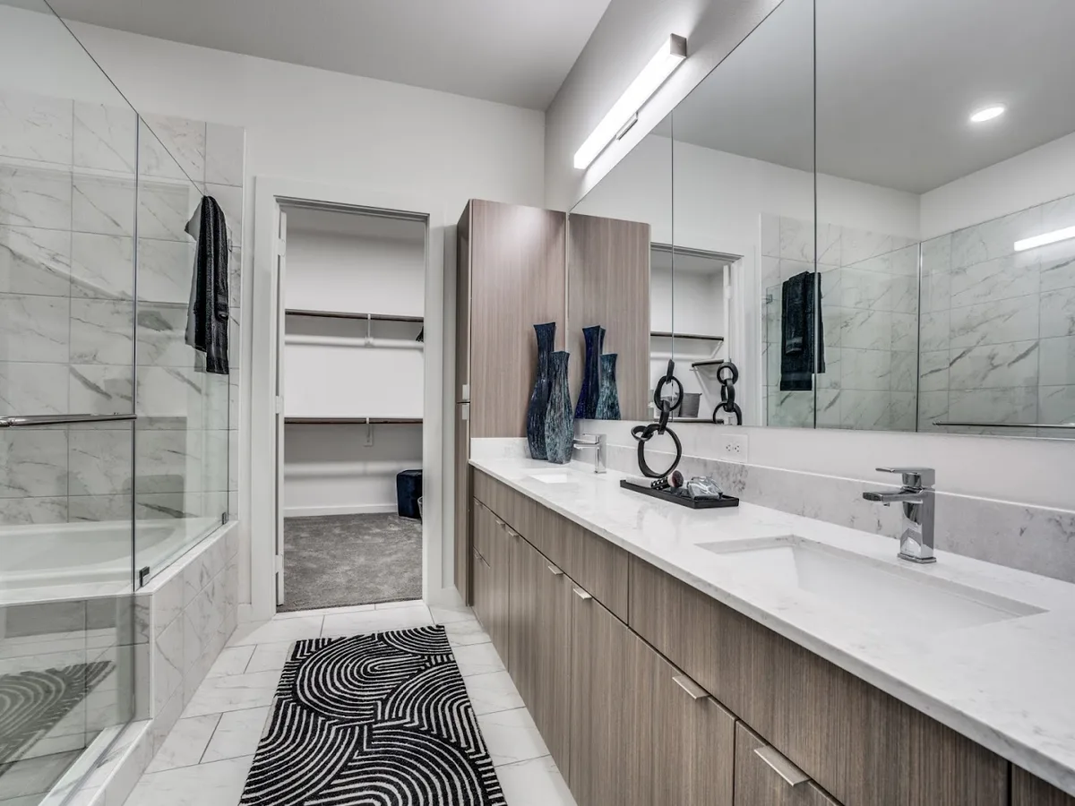 Primary bathroom with soaking tub, glass shower and adjoining walk-in closet
