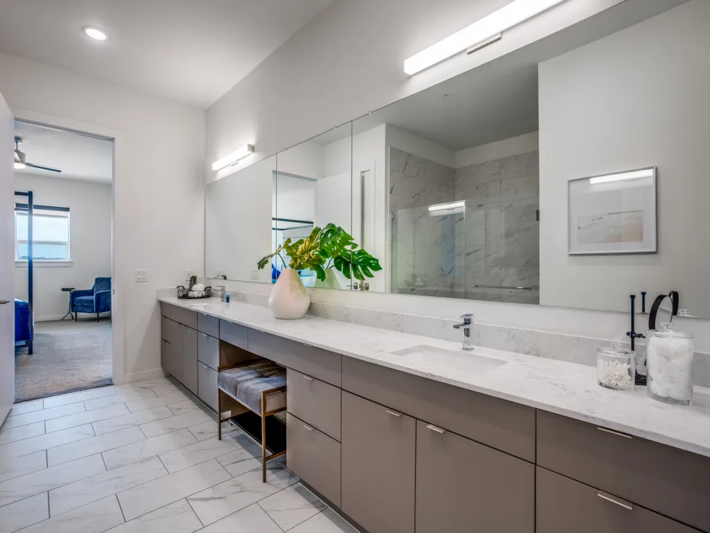 Primary bathroom with double quartz vanity and marble glass walk-in shower