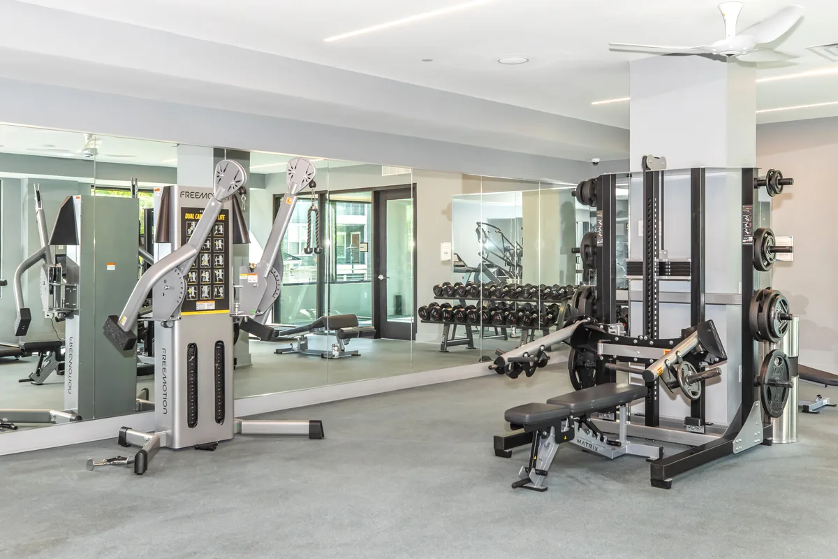 Fitness center with cable machine, free weights and a mirrored training area