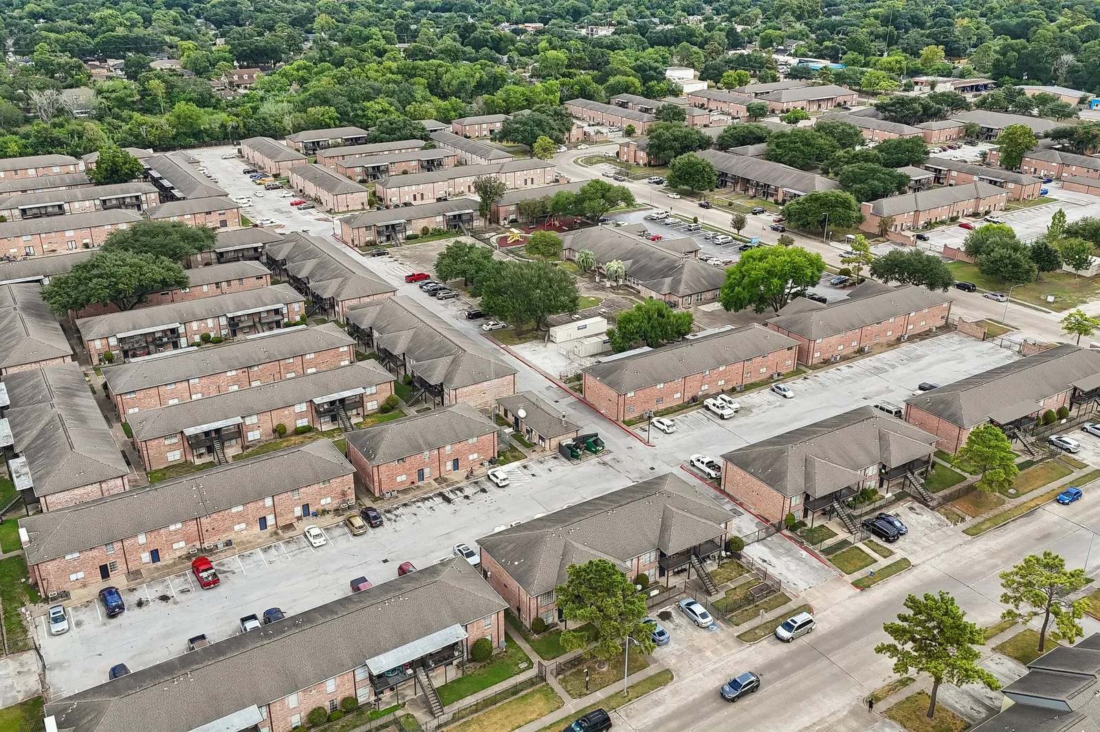 Aerial view of the community, brick residences and tree-lined parking off Dunlap Street