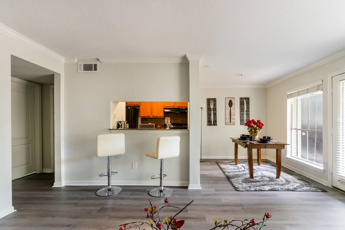 Dining nook off the breakfast bar with a set table and patio door