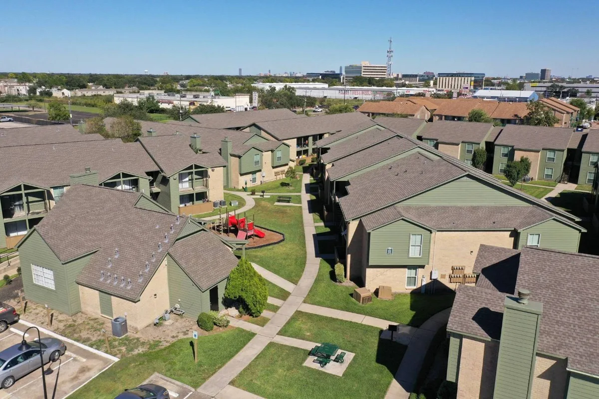 Aerial view of the gated community's rooftops, courtyards, and central playground