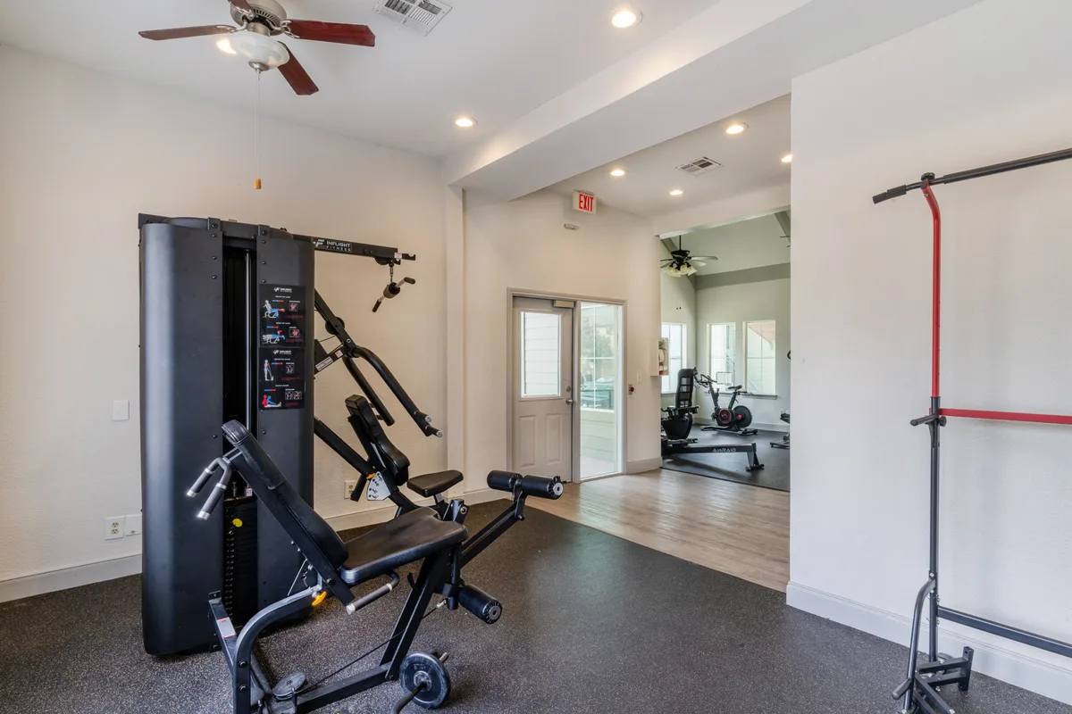 Strength-training area with a multi-station weight machine and adjustable bench