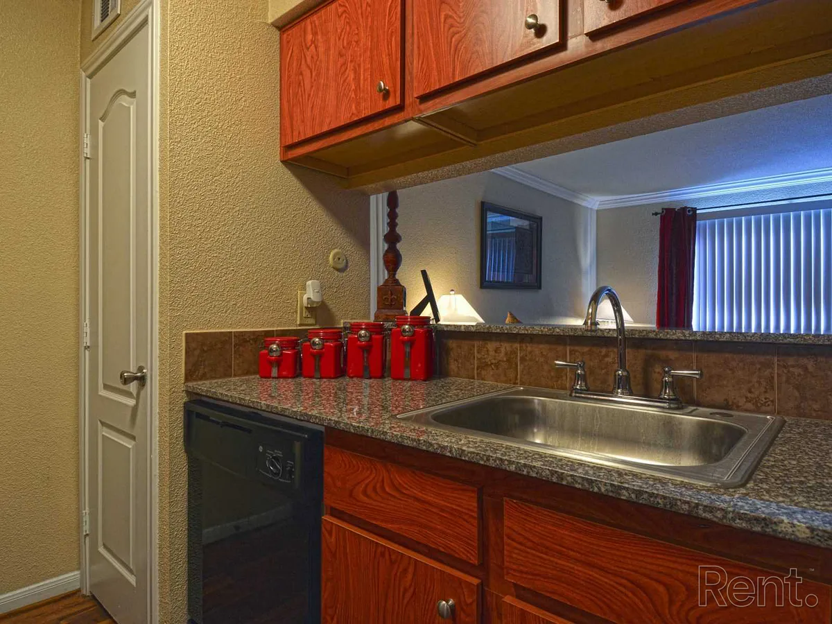 Kitchen sink and counter with a pass-through window to the living area