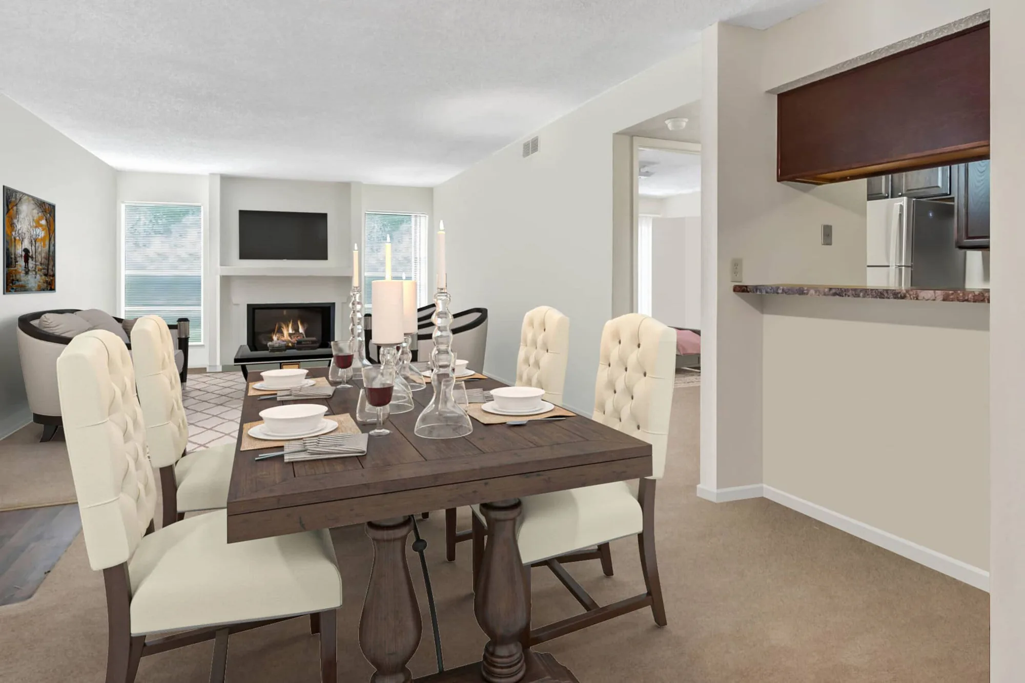 Dining table set for four in front of a fireplace and living area with a mounted TV