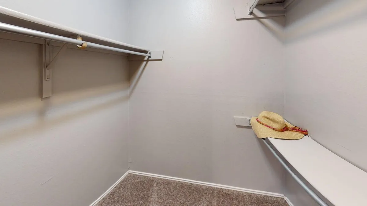 Walk-in closet with built-in shelving and hanging rods