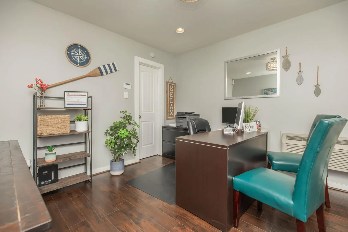 Leasing office interior with a welcome desk, seating, and nautical lake-themed decor