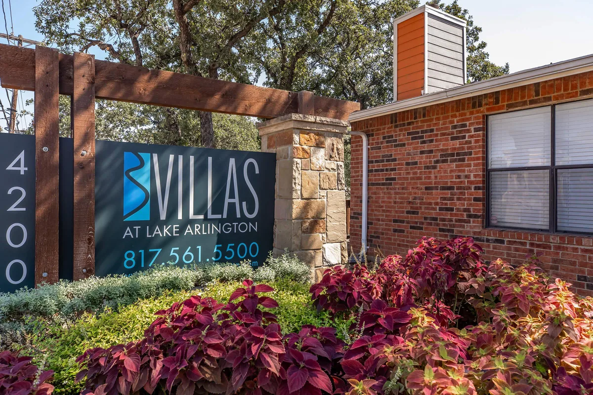 Villas at Lake Arlington property sign set in colorful landscaping at the community entrance