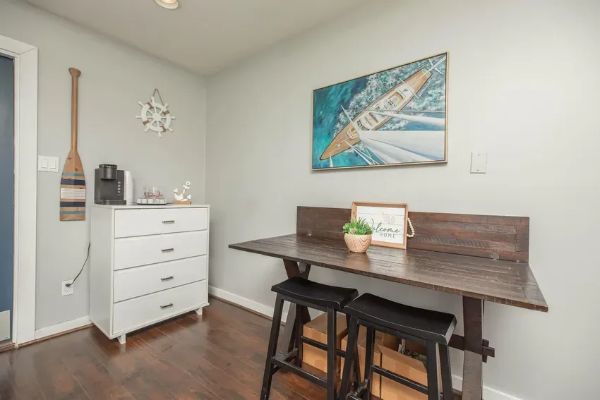 Dining nook with a wood table, saddle stools, and a built-in coffee station