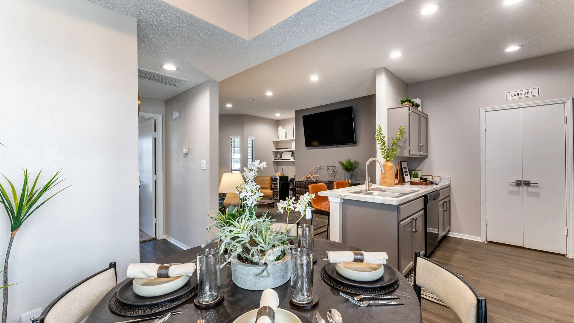 Dining nook with a round table beside the kitchen island and patio door